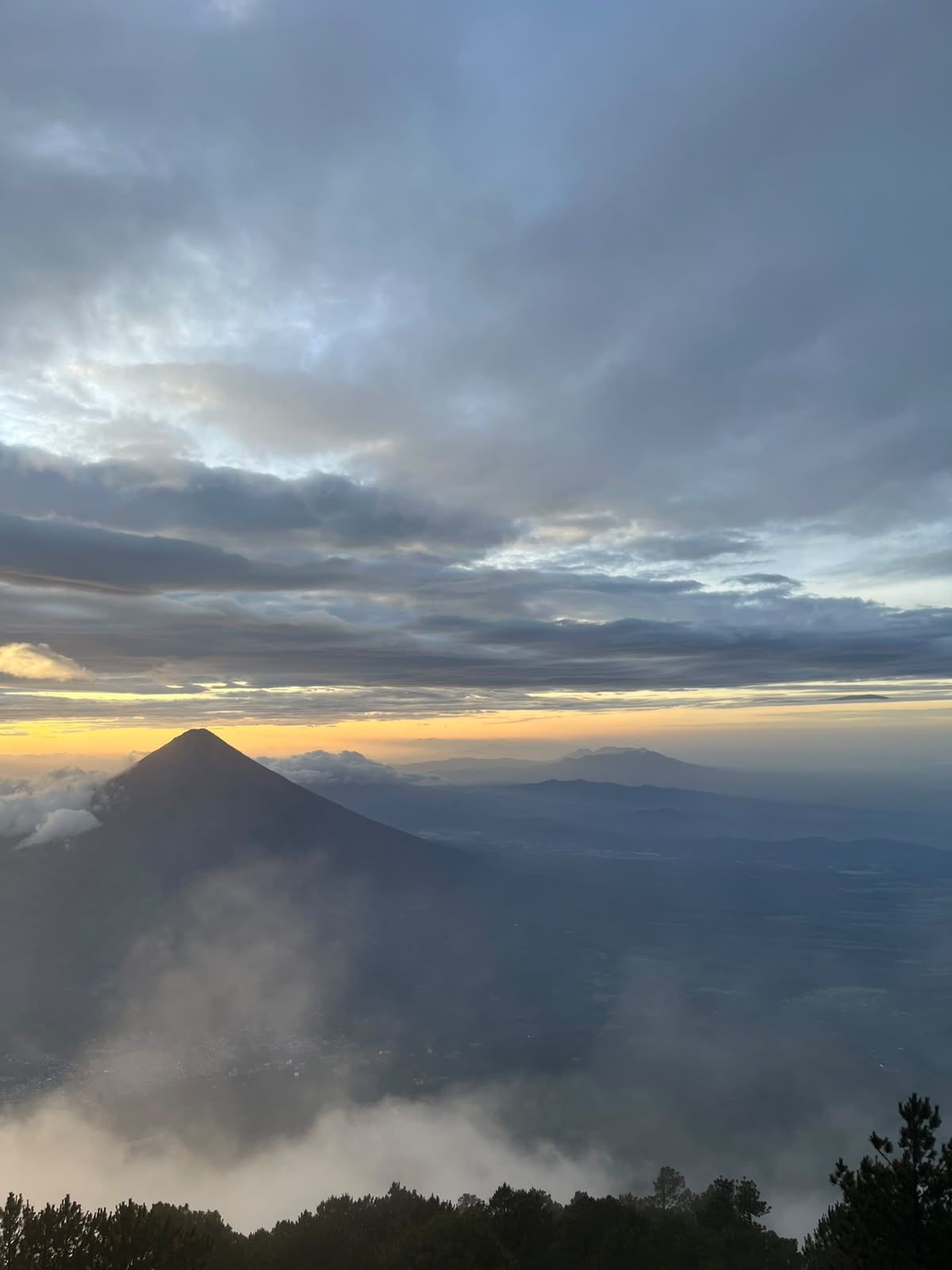 Agua volcano rising above a sea of dawn mist, seen from the Acatenango trail