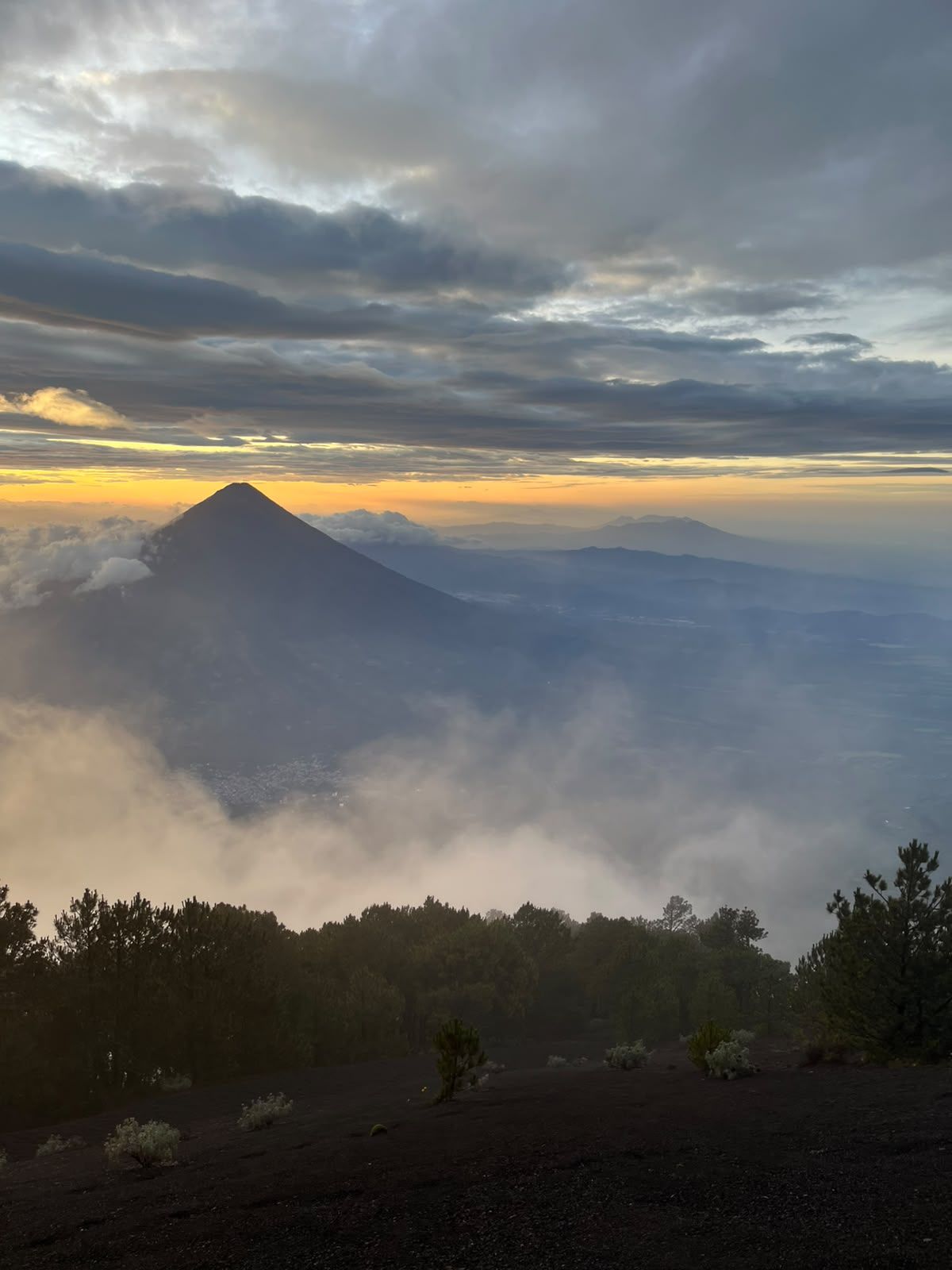 Daybreak over Agua volcano from the volcanic scree slope high on Acatenango