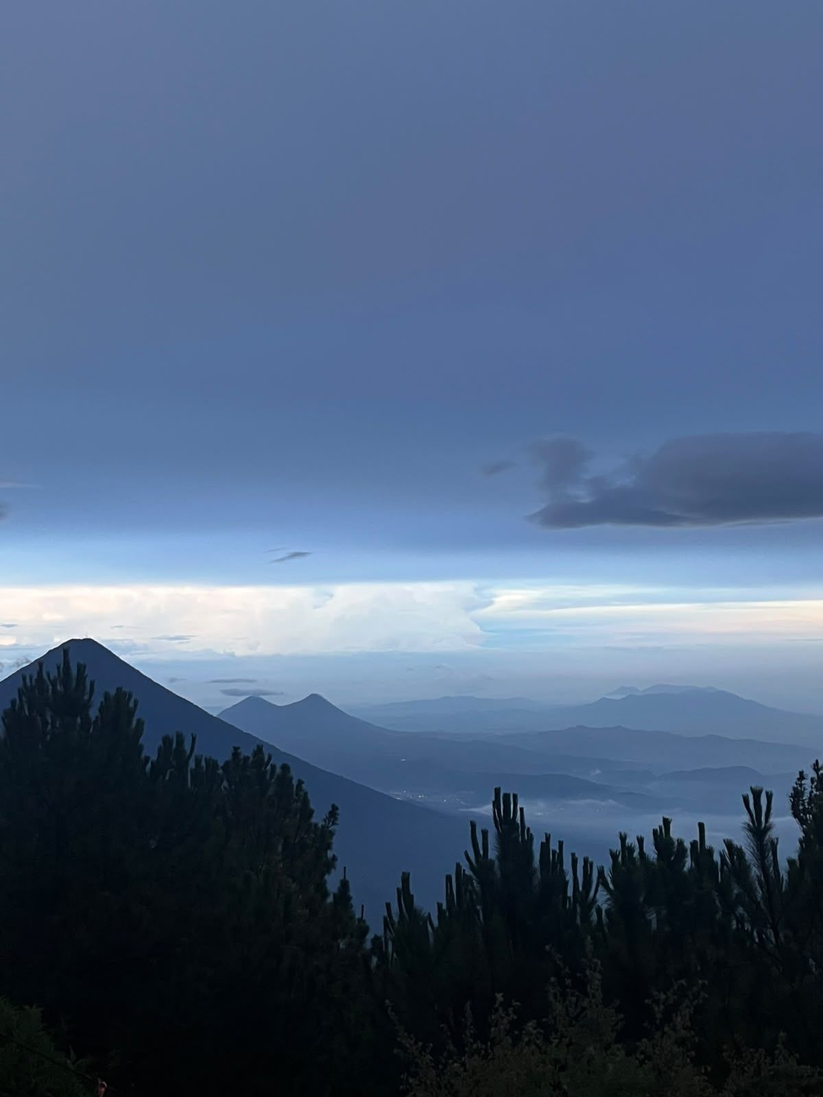 Volcano chain silhouetted in blue dusk light from Acatenango high camp