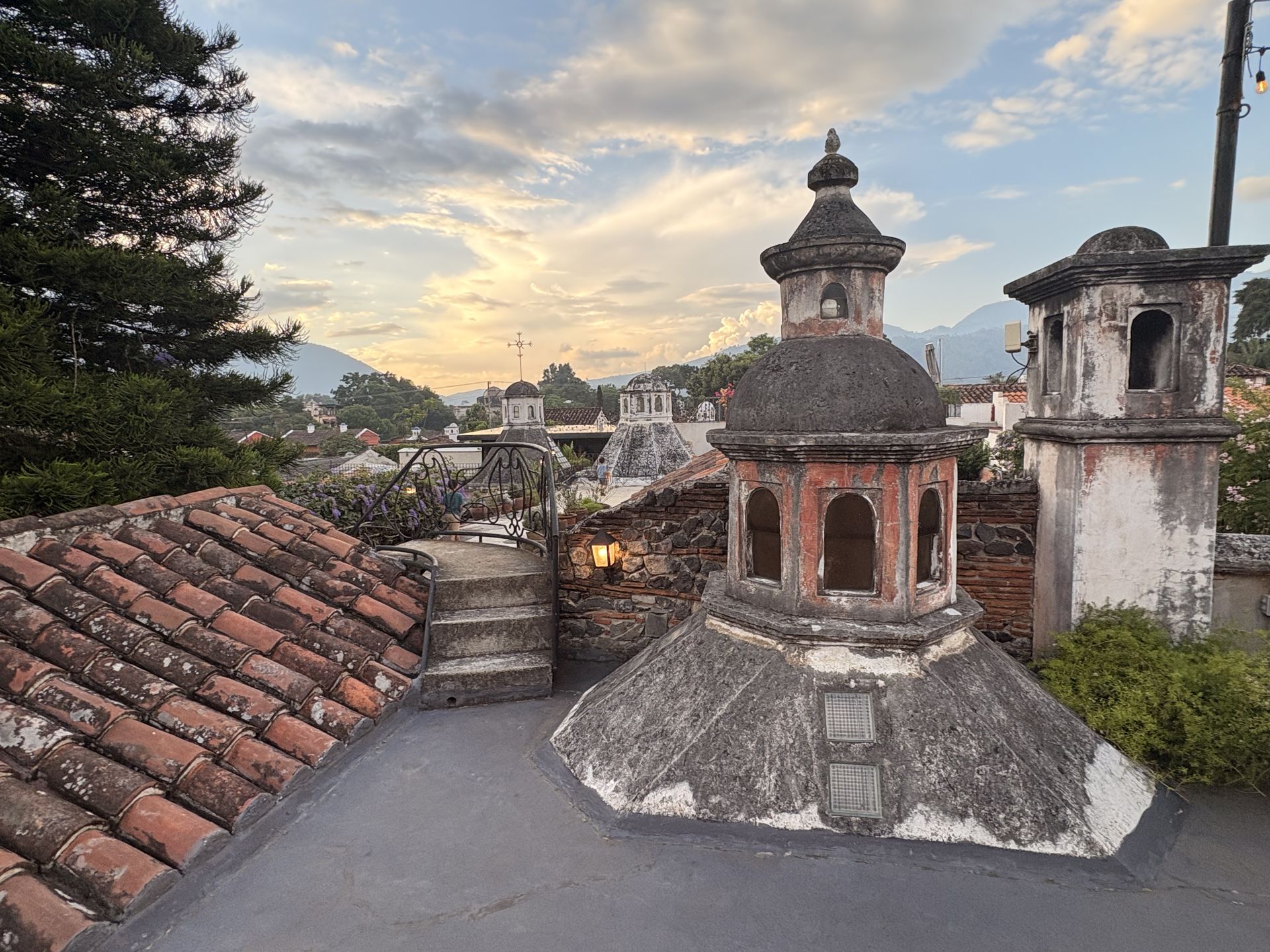 Whitewashed church cupolas and weathered tile rooftops of Antigua Guatemala in warm light