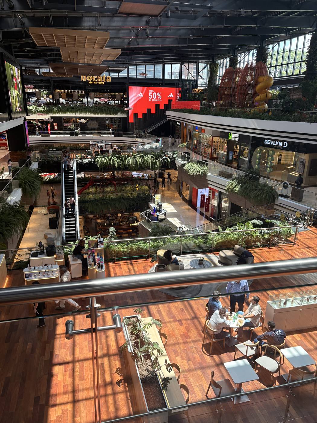 Wood-decked terraces inside a Zona 10 shopping center