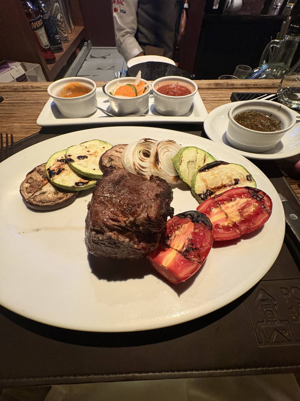 Grilled steak with charred vegetables and three salsas at a Guatemala City steakhouse