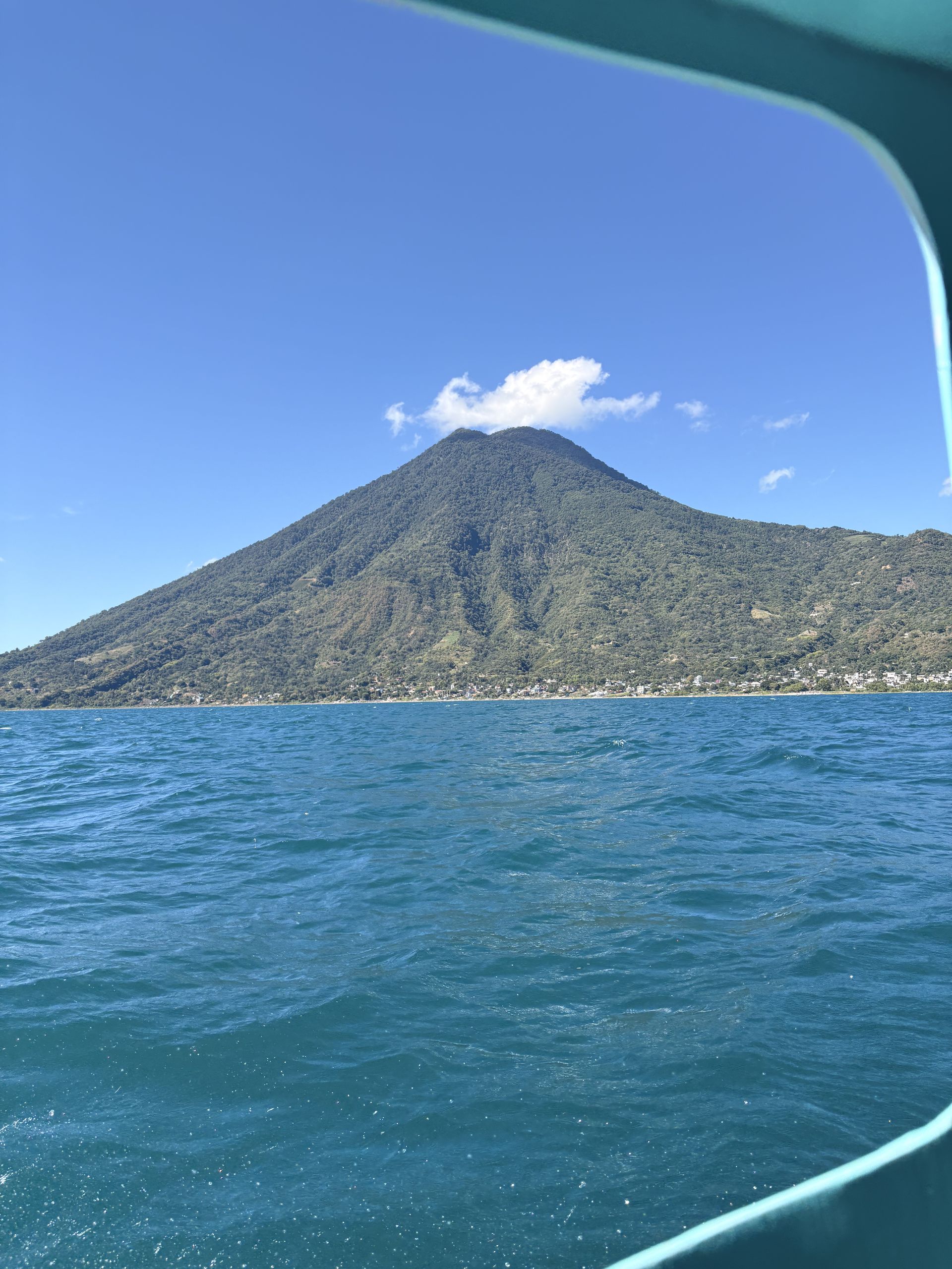 Volcán San Pedro rising over the turquoise water of Lake Atitlán, seen from a private boat