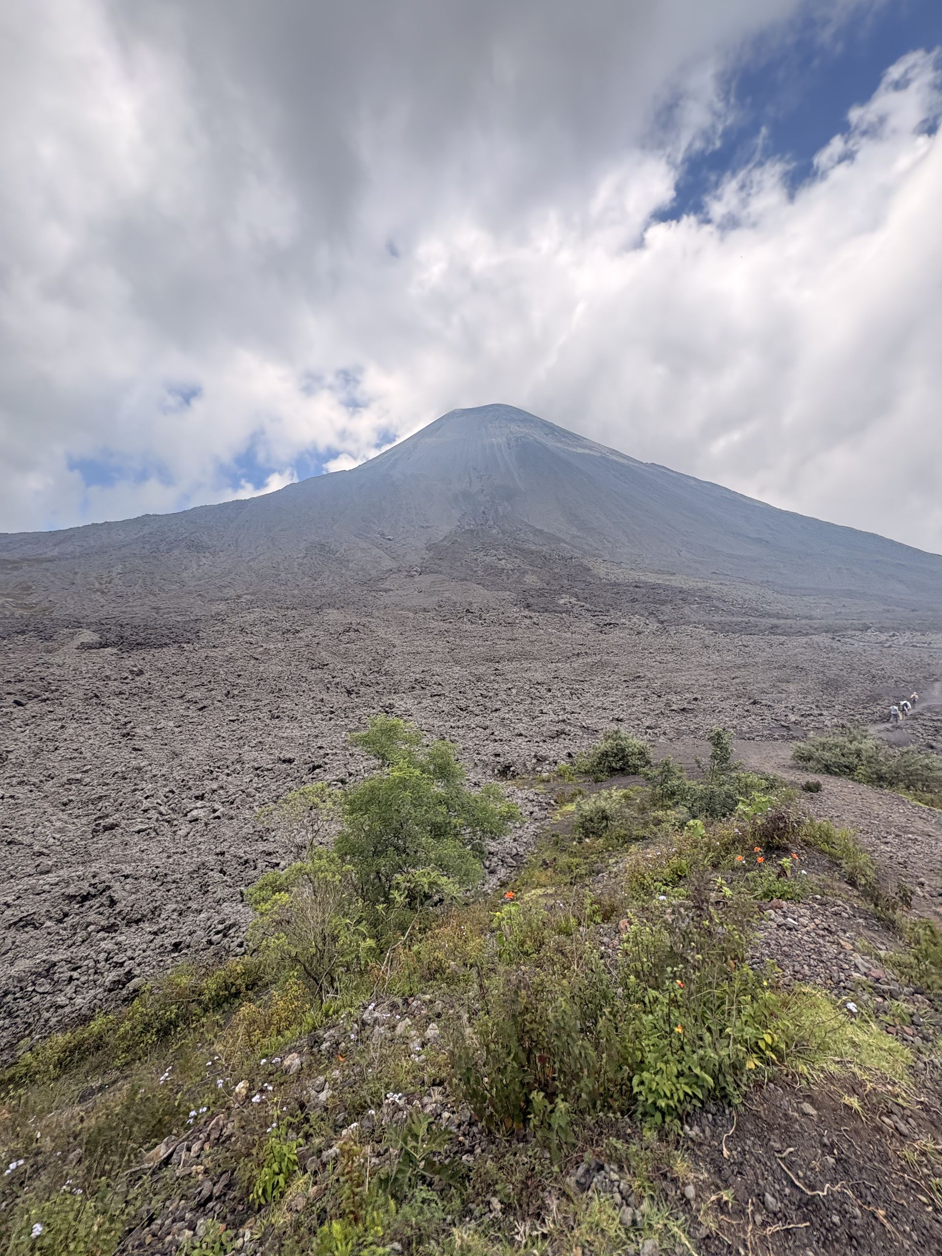 The bare upper cone of Pacaya volcano under moving cloud, Guatemala
